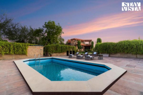 StayVista at The Cityscape with Lawn & Pool